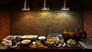 A buffet setup with various food items, condiments, and beverages. - Casa Forno Country Hotel (Otjiwarongo)