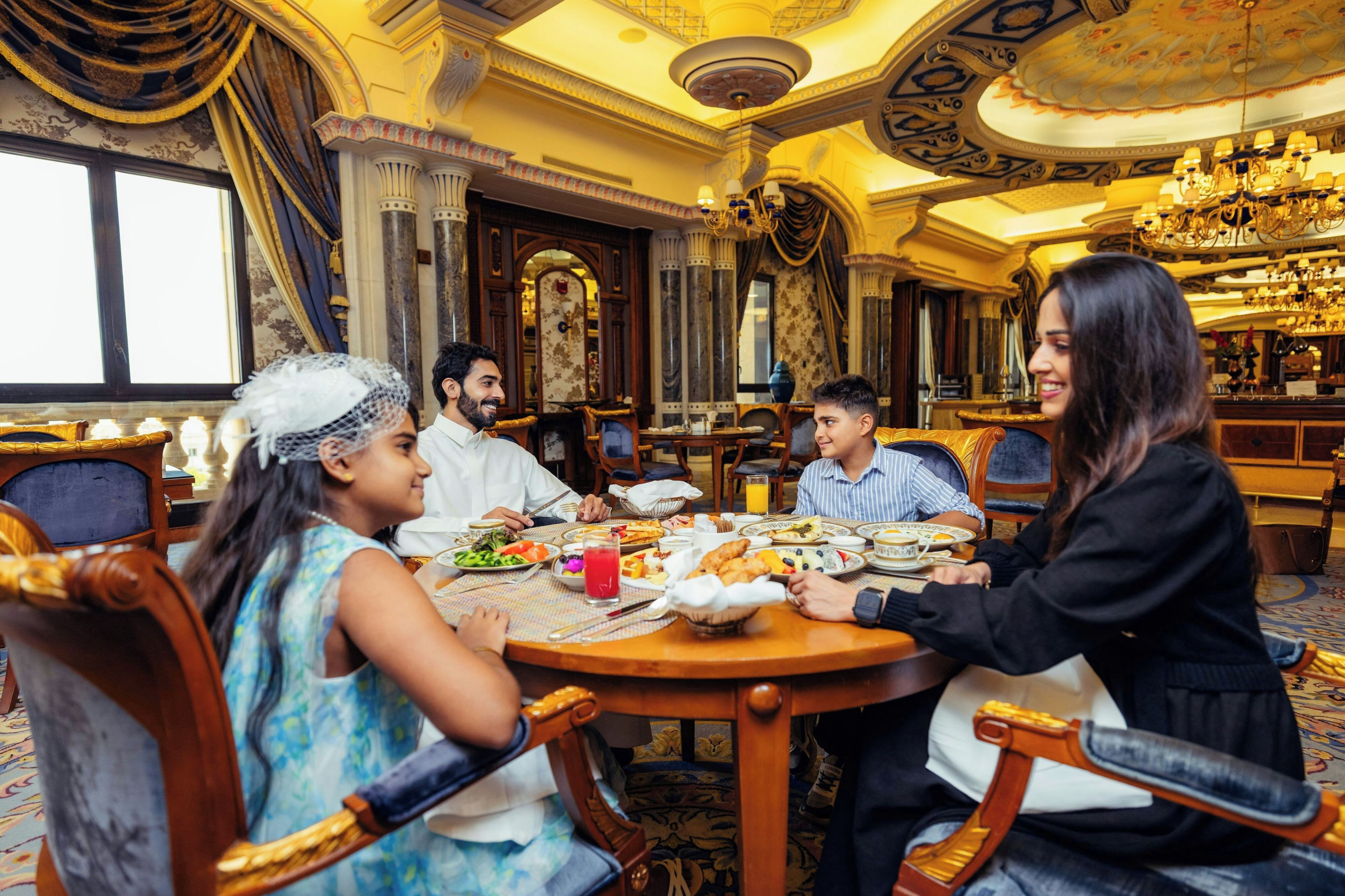 Un comedor con decoración elaborada, un candelabro y un amplio ventanal.