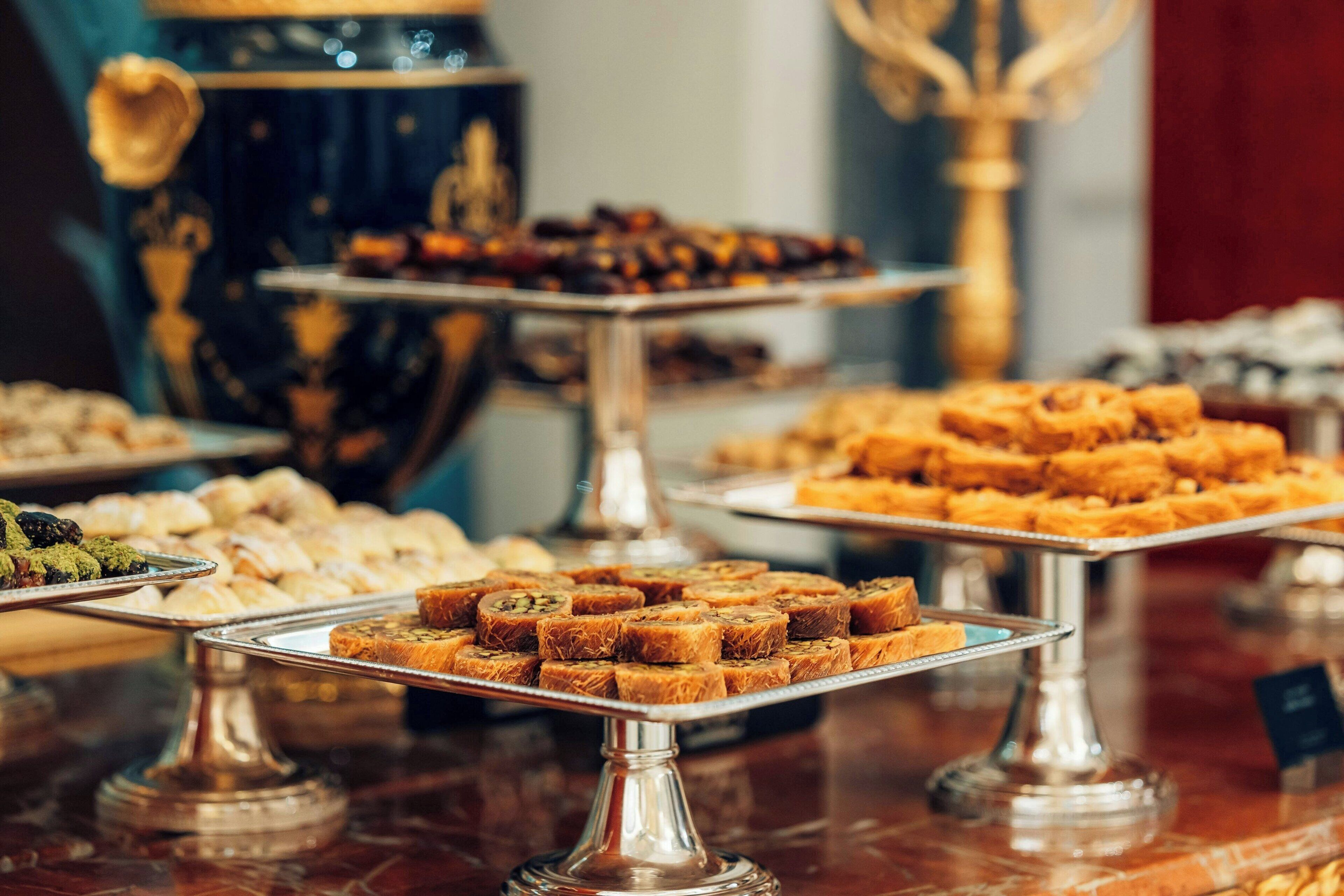 A buffet table with various desserts and pastries.
