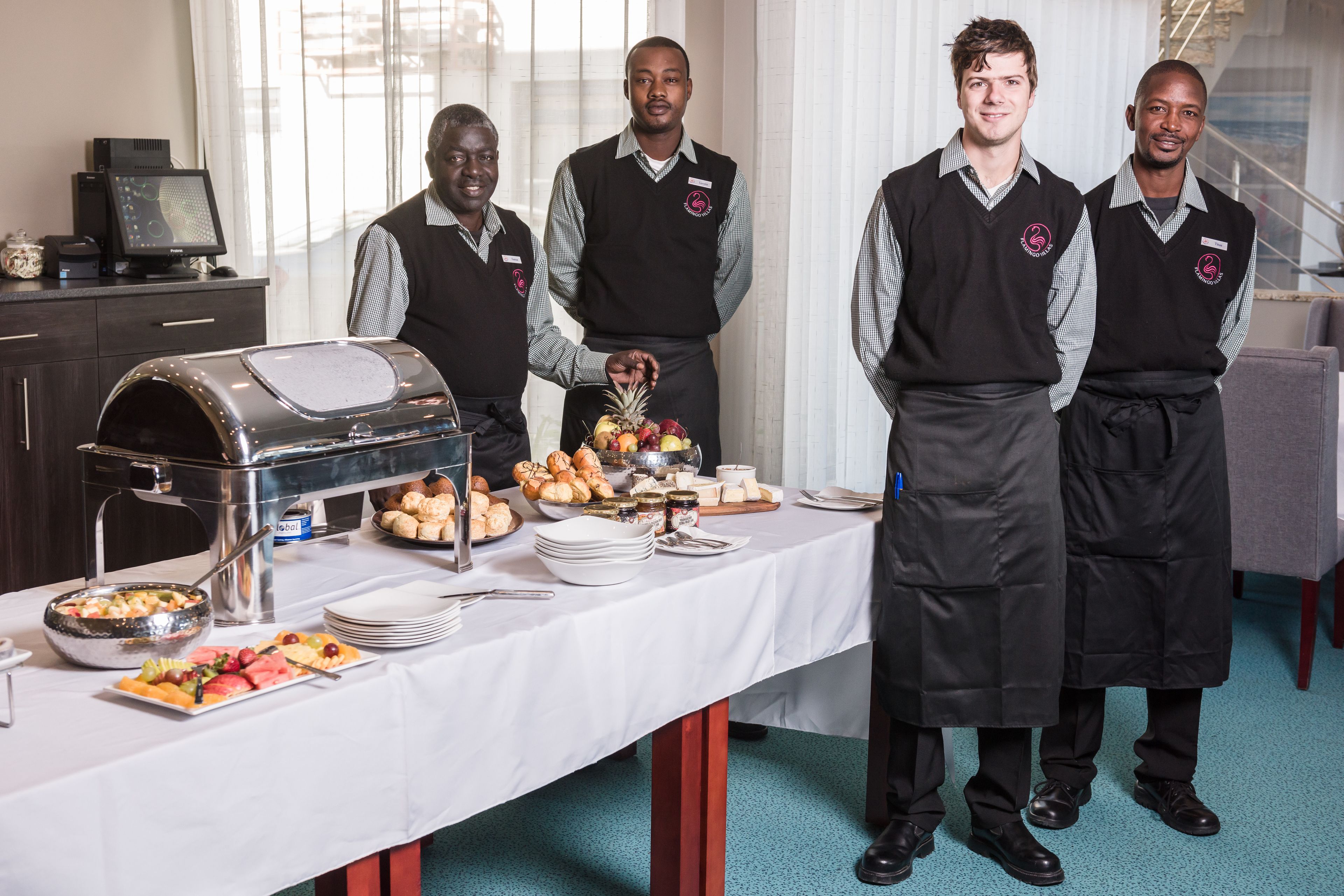 A buffet setup with various food items and a digital scale.