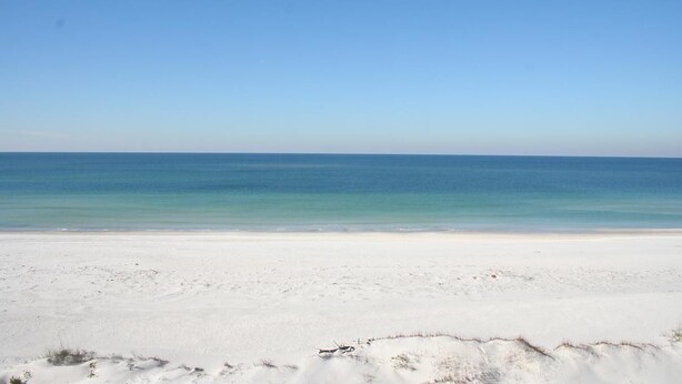 A beach with a clear sky and calm sea. - Cape Cottage (Port St. Joe)