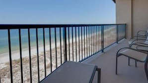 A balcony with a view of the beach, a railing, and a few chairs. - 4 Better Vues (Port St. Joe)