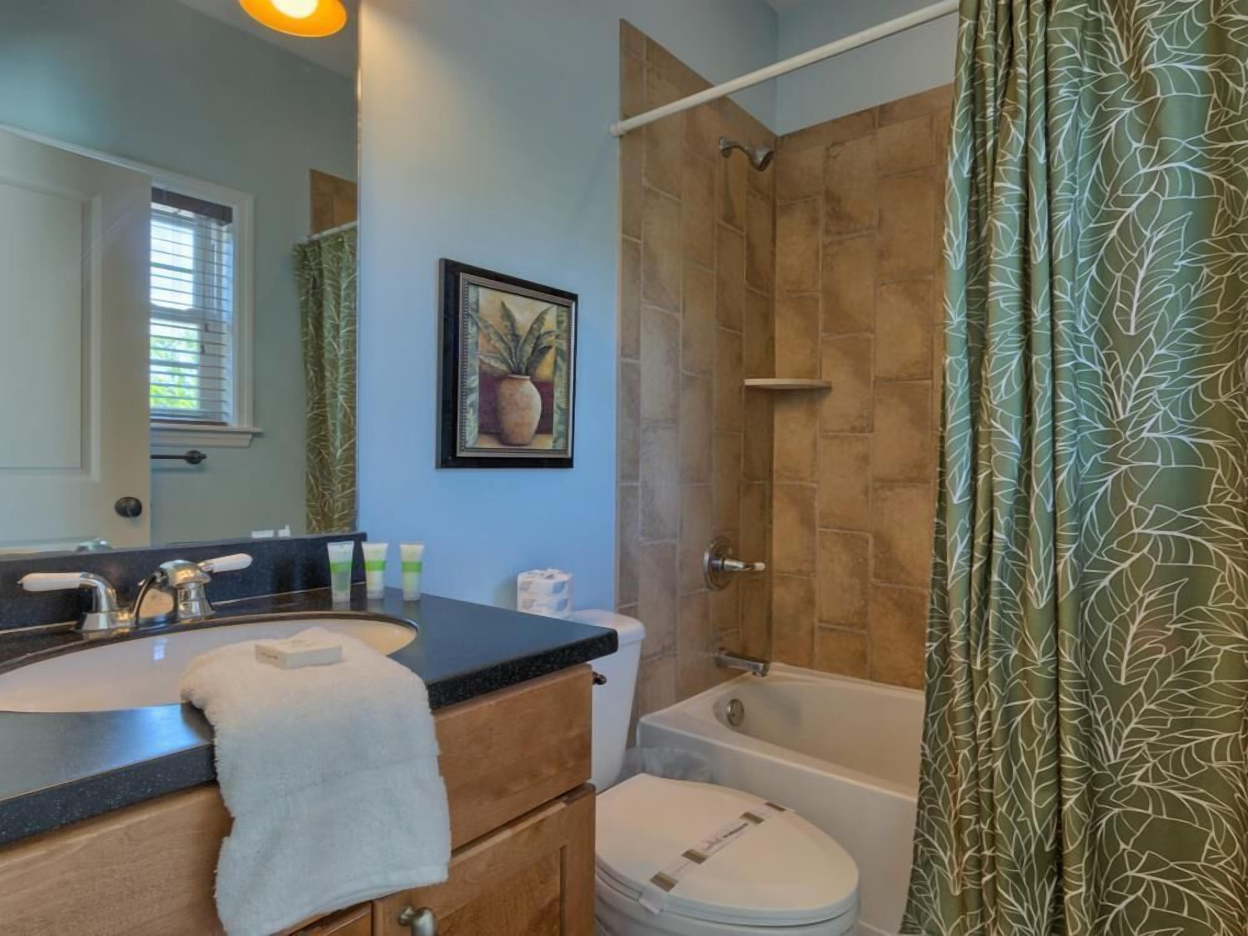 A bathroom with a sink, toilet, and bathtub.