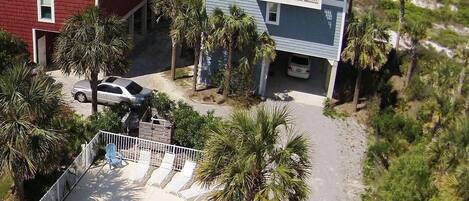 A two-story building with a pool and a beach view.