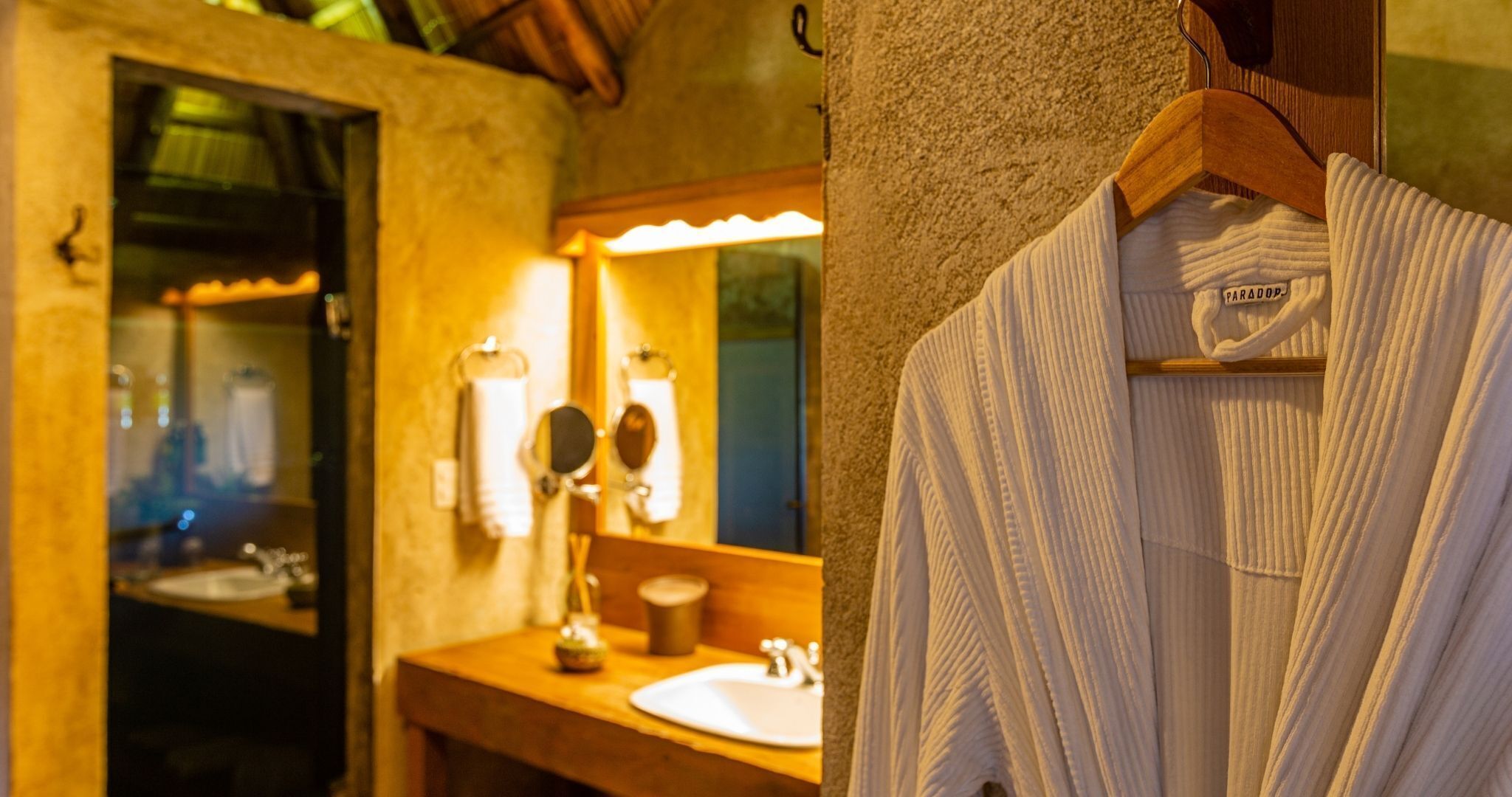 A bathroom with a sink, mirror, and towel rack.