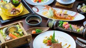 A variety of dishes on a wooden table, including seafood, vegetables, and a dessert.