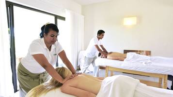 Relax and rejuvenate in our serene massage therapy area, featuring two comfortable massage tables.
