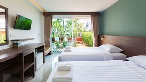A hotel room with a desk, two beds, a TV, and a view of the outdoors. - Parida Resort (Choeng Thale)