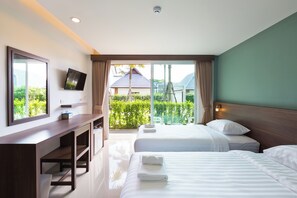 A hotel room with a bed, a desk, a TV, and a view of the outdoors. - Parida Resort (Choeng Thale)