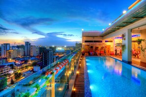 A rooftop infinity pool with a city view, glass railings, and ambient lighting. - Orussey One Hotel & Apartment (Phnom Penh)