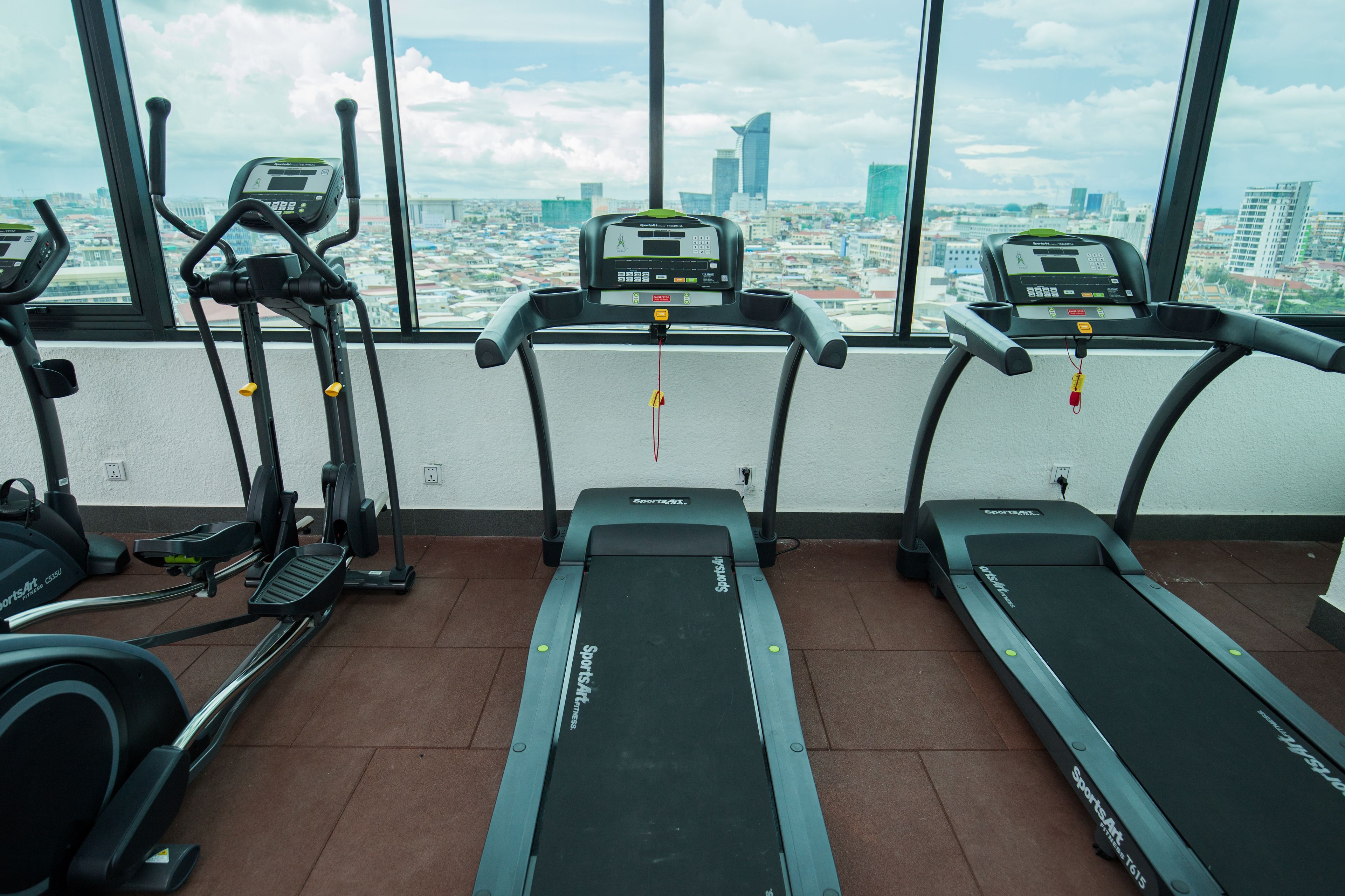 A gym with treadmills, stationary bikes, and elliptical machines.