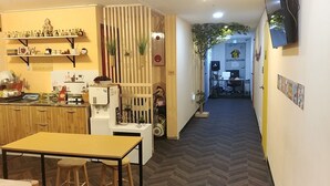 A kitchen with a dining area, a water dispenser, and a switchboard. - 24 Guesthouse Seomyun (Busan)