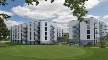 Residential complex with clean, white facades and large windows.