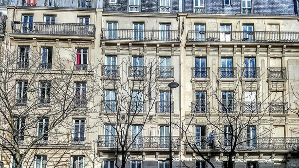 A multi-story building with a classic architectural style, featuring balconies and large windows. - Acacia Hotel (Paris)