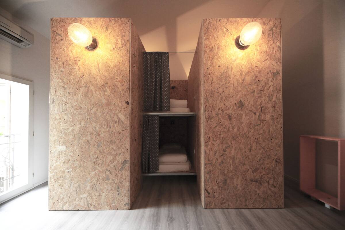 A modern bathroom with a wooden wall design, a shower area, and a visible toilet.