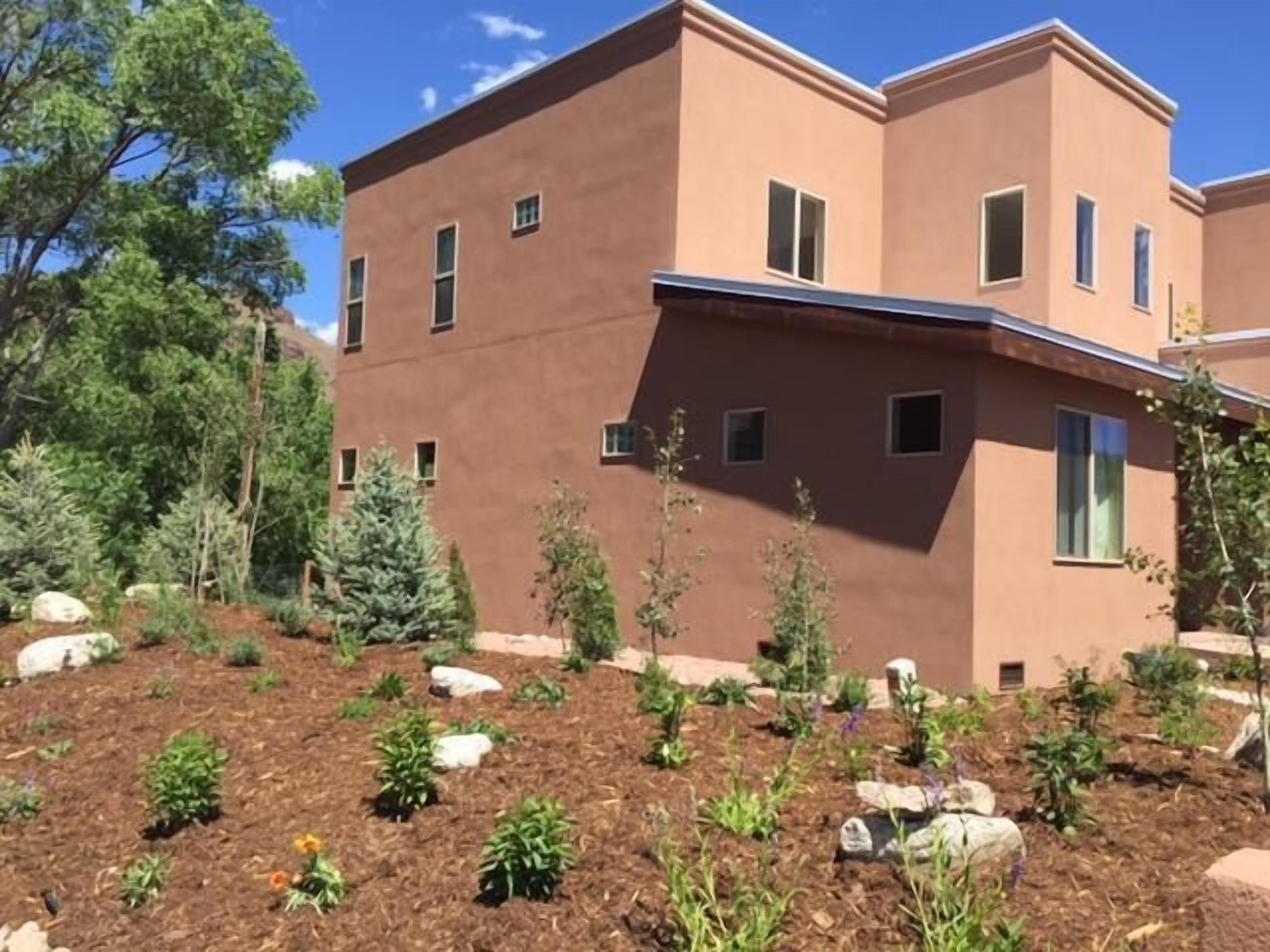 A modern building with a flat roof and multiple windows.