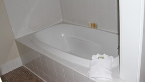 A white bathtub with a towel on the side. - Morning Glory 303 (Port St. Joe)