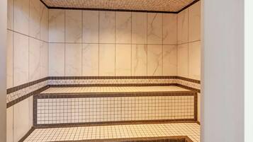 Bathroom features a tiled floor with a grid pattern and a raised area with steps.