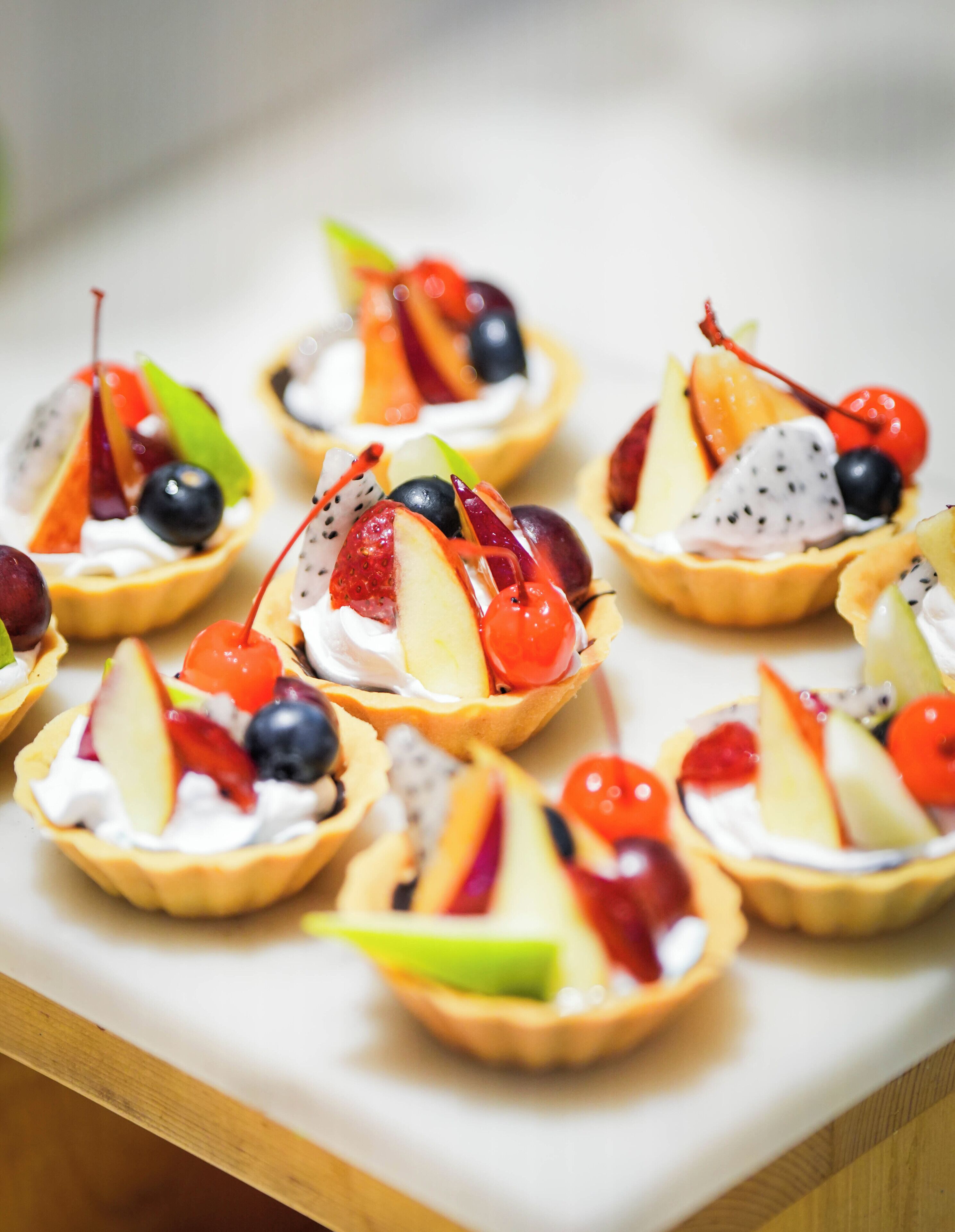 A tray of fruit-topped mini pies.