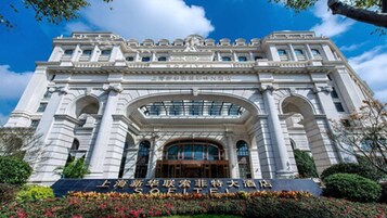 A grand building with classical architecture, featuring large arched windows and a prominent entrance.