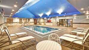 A swimming pool area with lounge chairs and a ceiling with a blue design. - Towneplace Suites Dover Rockaway (Dover)
