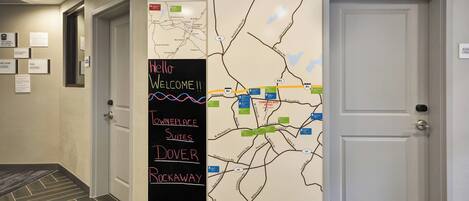 A hallway with a map highlighting 'Downtown Suites Dover' and 'Downtown Suites Brockaway'.