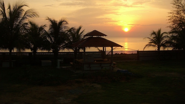 A sunset view with a gazebo and palm trees. - Bayu Beach Penarek (Setiu)