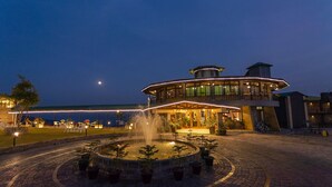 A hotel with a circular fountain, outdoor seating, and a view of the sea. -  Polo Cherrapunjee Resort  (Shillong)