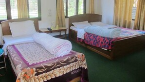 A hotel room with two beds, a desk, and a chair. - Green Park (Pokhara)