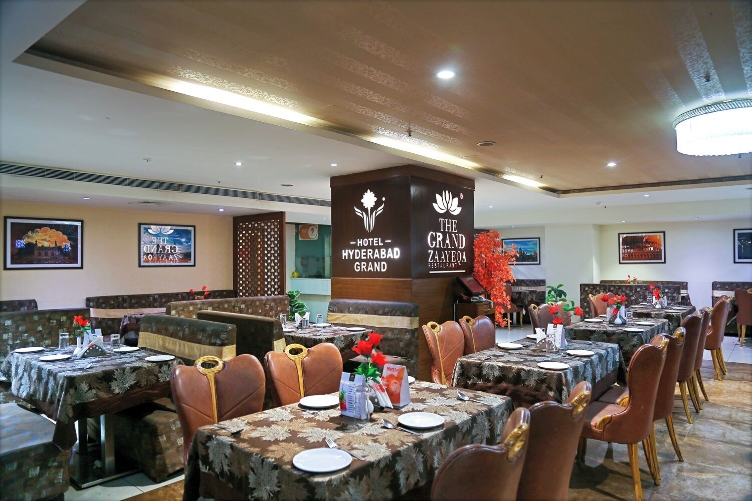A restaurant with multiple dining tables and booths, each set with plates, cutlery, and a menu.