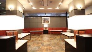 A lobby with a checkered floor, red seating, and a framed picture on the wall. - Hikone Biwako Hotel (Hikone)