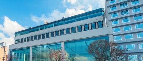 A modern building with large glass windows and a flat roof.