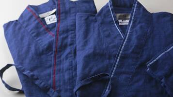 Two blue robes with red trim and a tag labeled "F".
