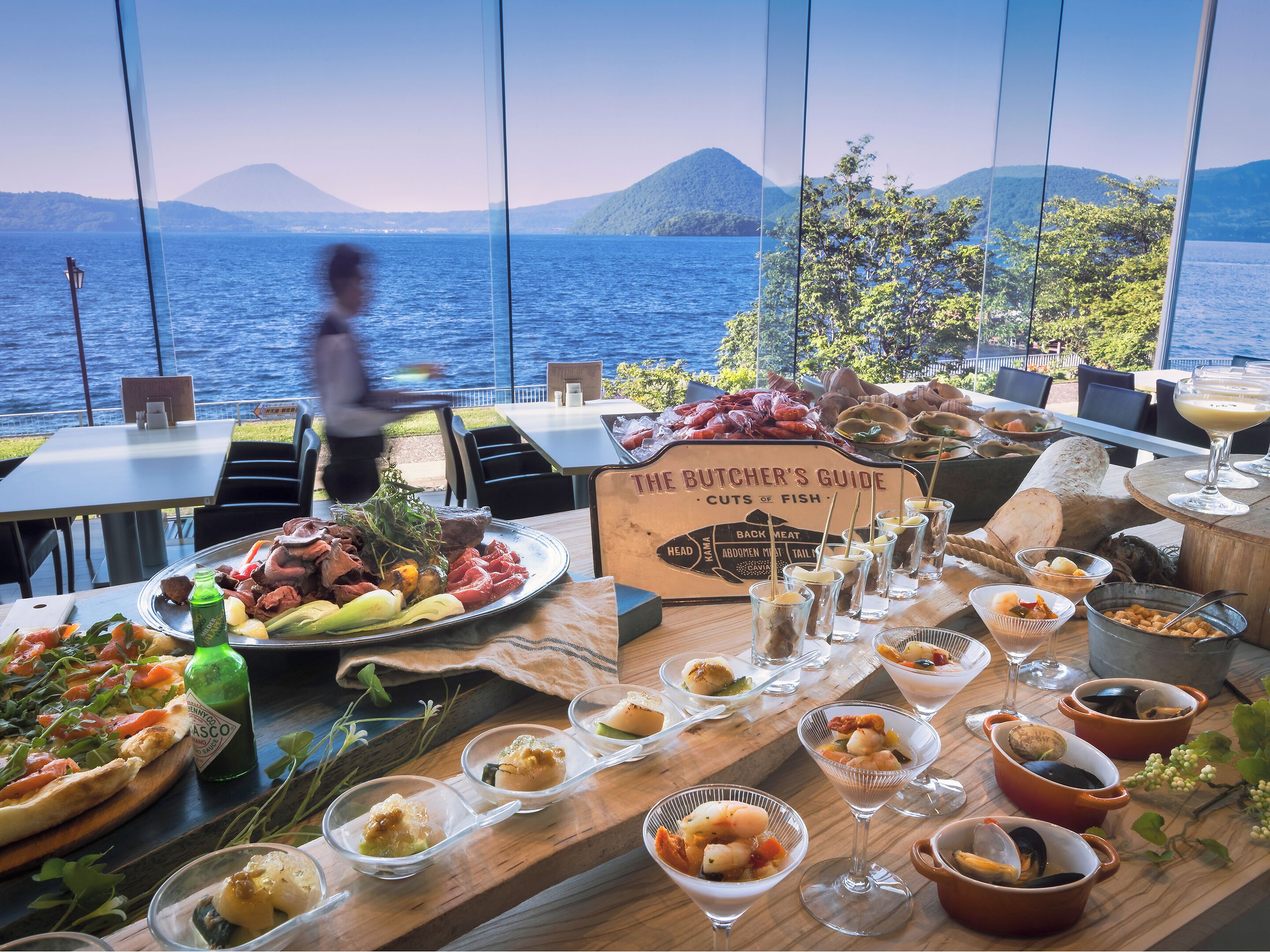 A seafood restaurant with a view of the sea and mountains.