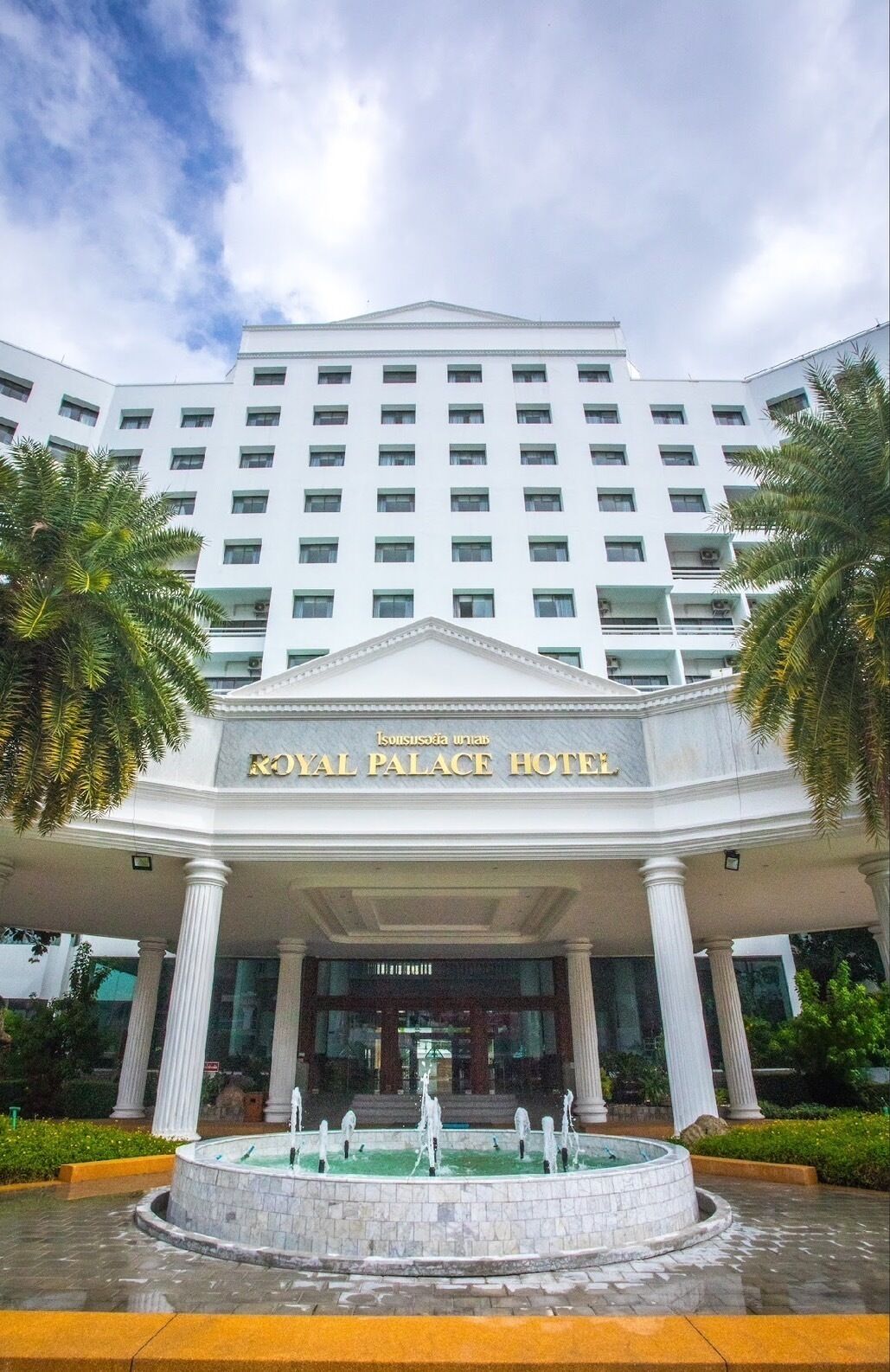 The exterior of the Royal Palace Hotel with a central fountain, white columns, and a large entrance.