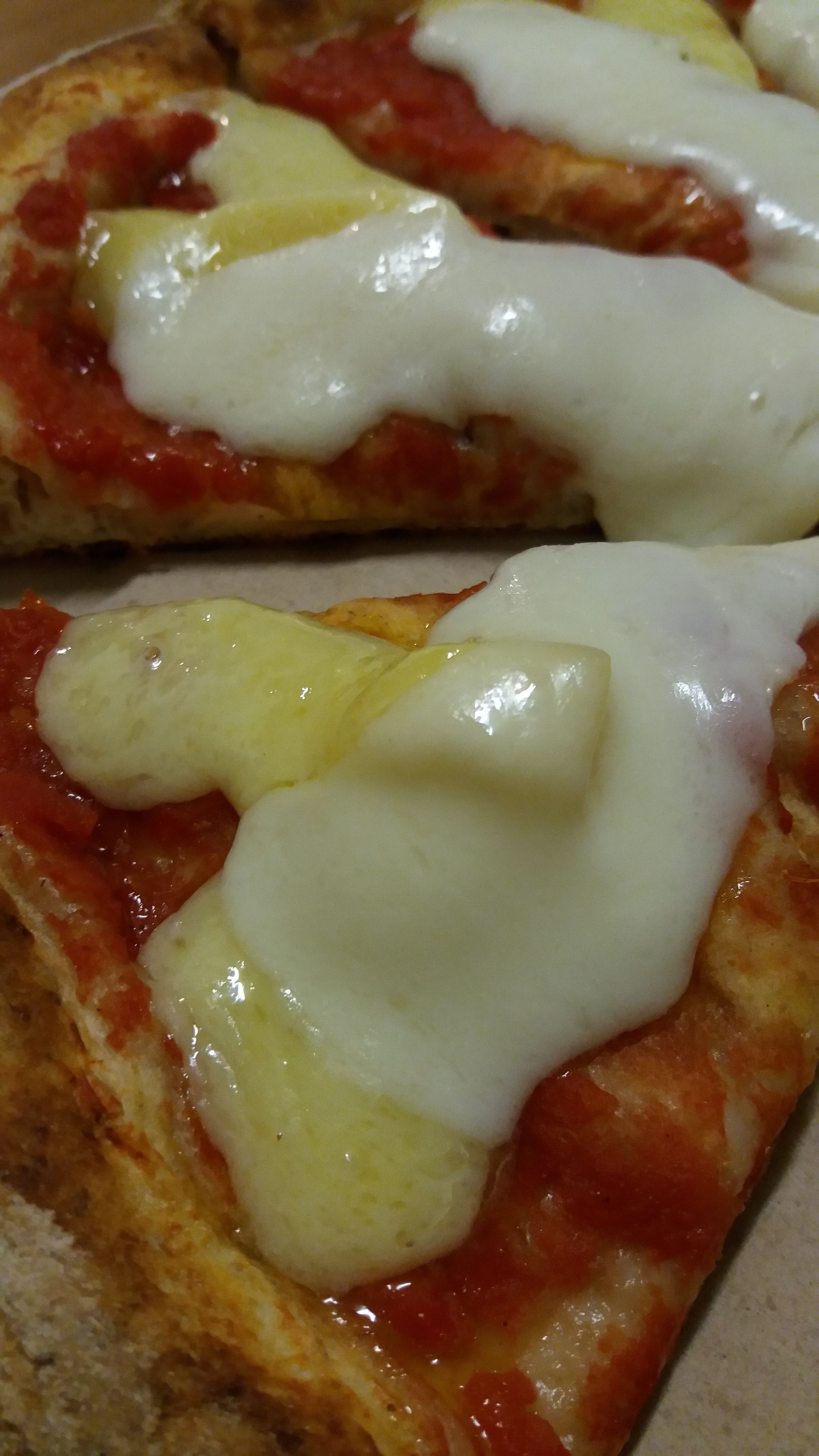 A pizza with cheese and tomato sauce.