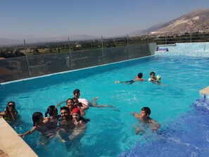 Relax by the pool surrounded by breathtaking mountain views.