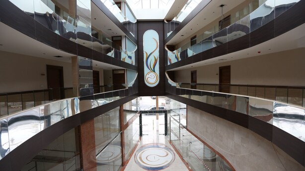 A multi-level atrium with glass railings and a central decorative feature. - Delora Hotel and Suites (Chtaura)