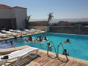 A swimming pool with lounge chairs and a view of distant mountains. - Delora Hotel and Suites (Chtaura)