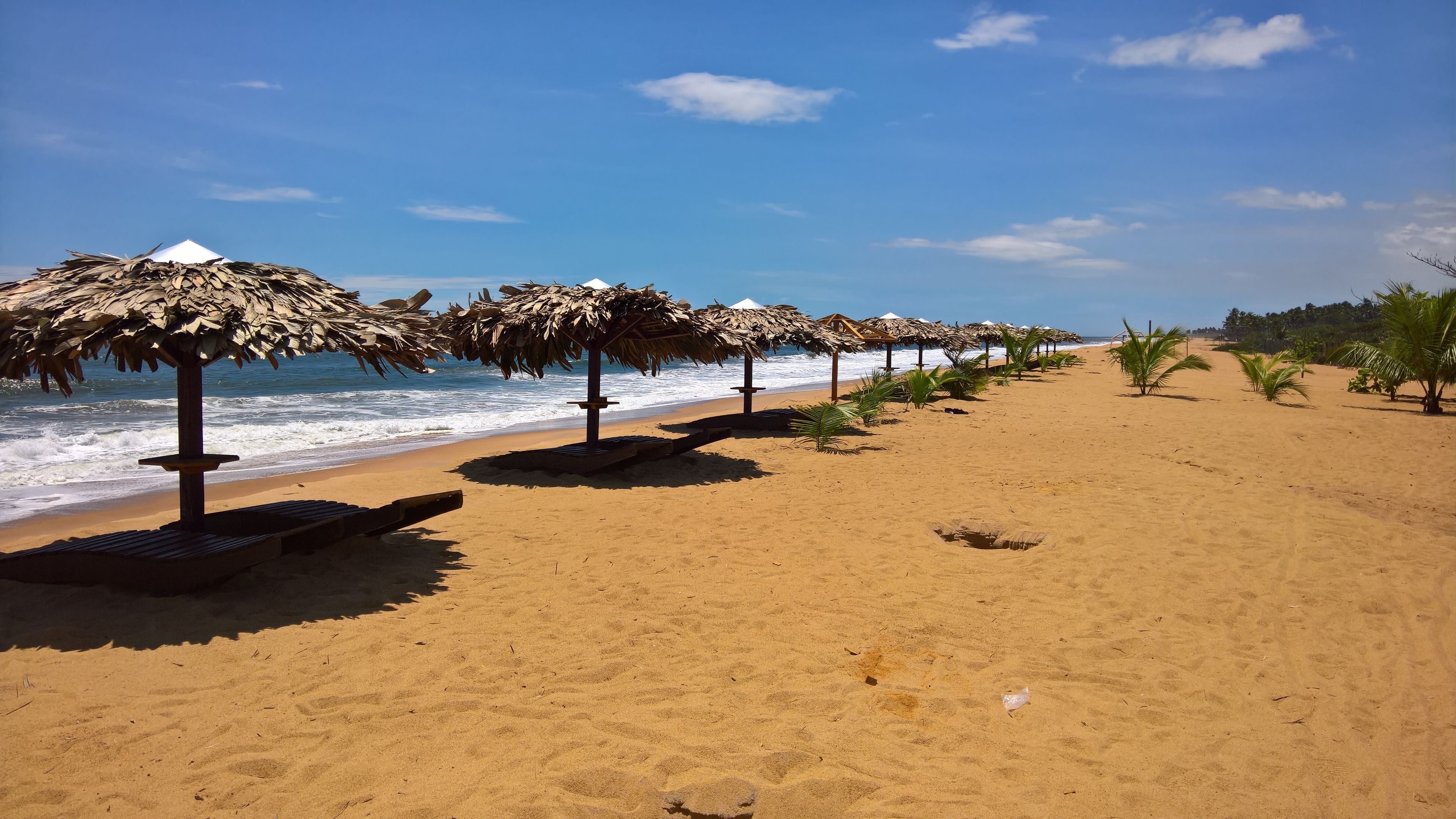 On the beach, white sand, sun-loungers, beach umbrellas