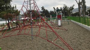 Ein Spielplatz mit Klettergerüst und Rutschen.