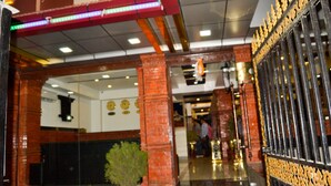 A lobby with a tiled floor, a potted plant, and a decorative gate. - Mandala Hotel Pvt.Ltd. (Kathmandu)