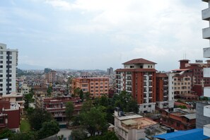 A high-rise building with multiple floors, surrounded by other buildings and greenery. - Mandala Hotel Pvt.Ltd. (Kathmandu)
