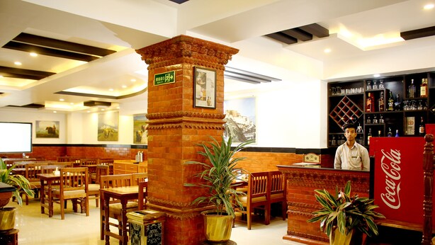 A hotel lobby with wooden furniture, a Coca-Cola refrigerator, and a reception desk. - Mandala Hotel Pvt.Ltd. (Kathmandu)