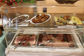 A buffet with various dishes including Blue & Liverwurst, Wurstplatte, and other meats.