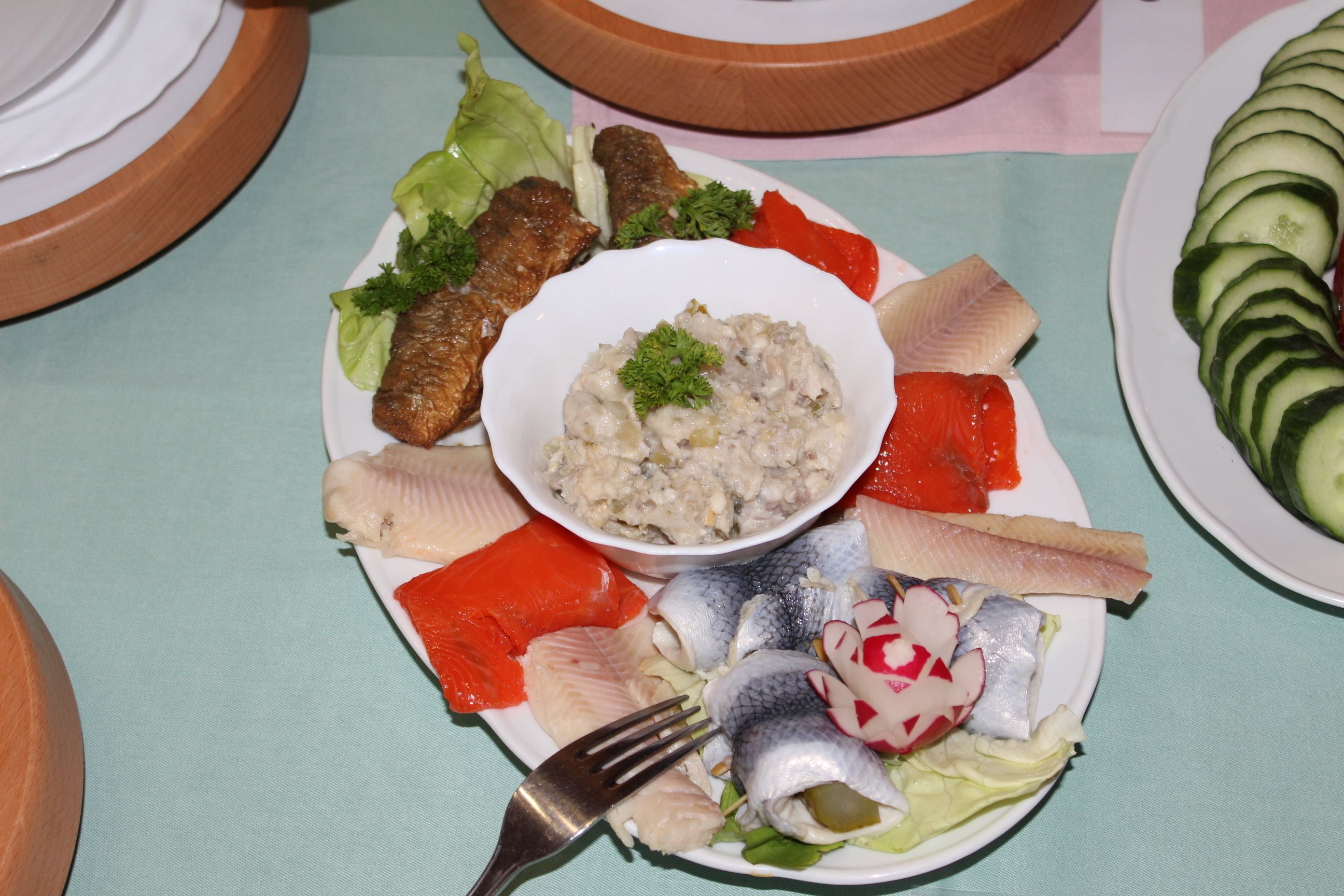 A plate of various fish and vegetables on a table.