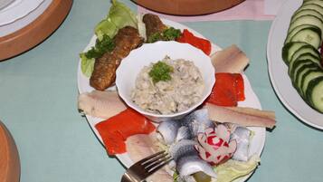 A plate of various fish and vegetables on a table.
