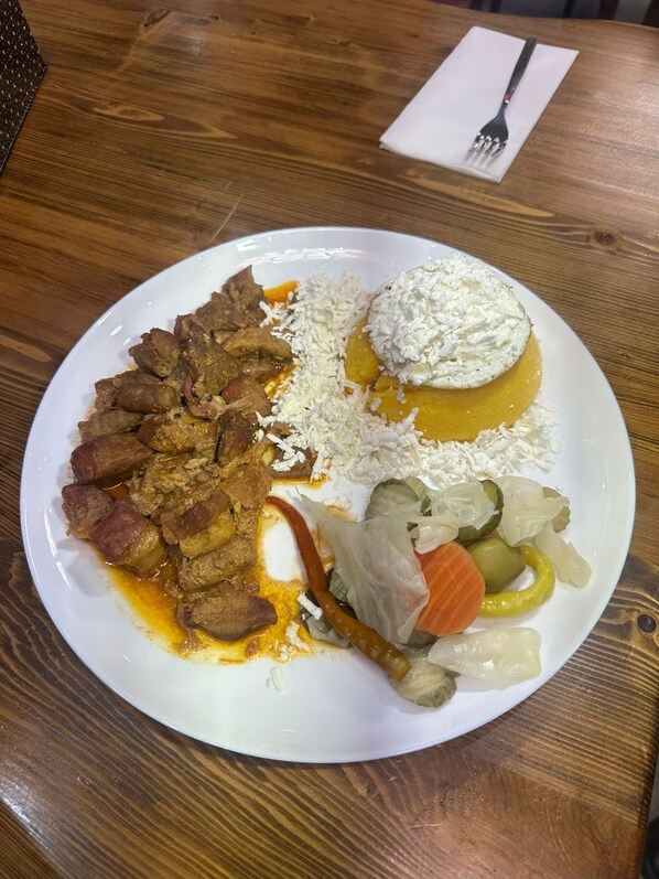 A plate of food with various items including meat, rice, and vegetables. - White Rose Hotel & Restaurant - Leeds (Leeds)