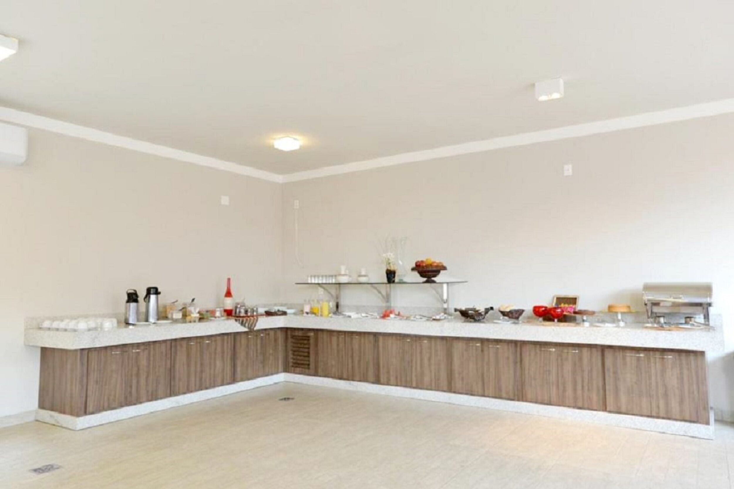A modern kitchen with a white countertop, wooden cabinets, and a built-in sink.