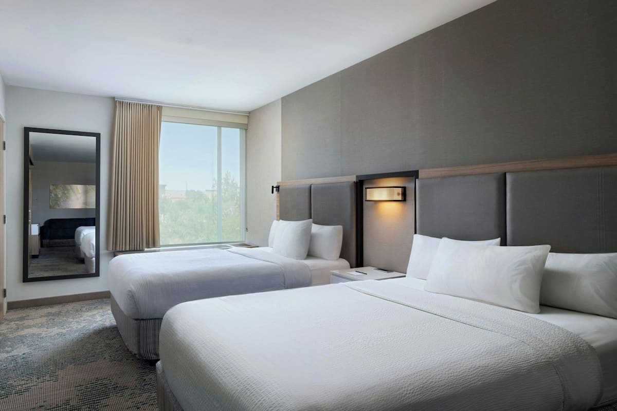 Premium bedding, desk, laptop workspace, blackout drapes
